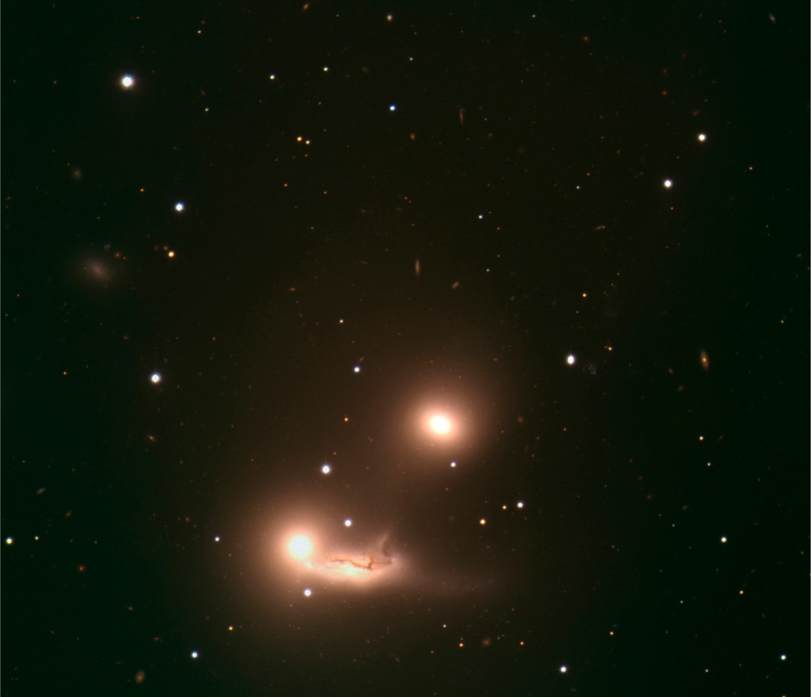 Colour-composite image of the triplet of galaxies, catalogued as NGC 7173 (top), 7174 (bottom right) and 7176 (bottom left), and located 106 million light-years away towards the constellation of Piscis Austrinus (the &#8216;Southern Fish&#8217;). This triplet of galaxies makes up part of the Hickson Compact Group HCG 90.  NGC 7173 and 7176 are elliptical galaxies, while NGC 7174 is a spiral galaxy with quite disturbed dust lanes and a long, twisted tail. This seems to indicate that the two lower galaxies &#8211; whose combined shape bears some resemblance to that of a sleeping baby &#8211; are currently interacting. Astronomers have suggested that the three galaxies will finally merge.  The size of the image is about 5.3 arcminutes. The image is based on data obtained with the VLT FORS1 instrument on ESO&#8217;s Very Large Telescope through three different filters, B, V, and R. The data were extracted from the ESO Science Archive and fully processed by Henri Boffin (ESO). 
